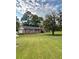Charming brick home with a well-maintained lawn and mature trees under a cloudy sky at 1838 Cates Ct, Snellville, GA 30078
