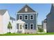 Charming two-story home with blue siding, gray roof, and a welcoming yellow front door at 2729 Creek View Nw Ter, Atlanta, GA 30318