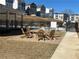 Community fire pit area with Adirondack chairs on a brick paver patio; neighborhood townhomes in background at 2729 Creek View Nw Ter, Atlanta, GA 30318