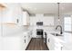 Stylish kitchen with white cabinetry, stainless steel appliances, and ample counter space at 2729 Creek View Nw Ter, Atlanta, GA 30318