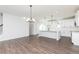 Open-concept living room and kitchen with sleek countertops and modern lighting fixtures at 2729 Creek View Nw Ter, Atlanta, GA 30318