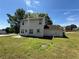 Exterior view showcasing a grassy backyard, vinyl siding, and access to a back door with a concrete patio at 3836 Wexford Dr, Douglasville, GA 30134