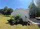 Side view of home featuring vinyl siding, satellite dish, concrete driveway, and surrounding lawn at 3836 Wexford Dr, Douglasville, GA 30134