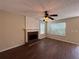 Spacious living room featuring a fireplace, ceiling fan, and hardwood floors at 3836 Wexford Dr, Douglasville, GA 30134