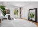 Stylish bedroom with a modern lounge chair, large mirror, and access to an outdoor area through sliding glass doors at 53 Daniel Se St, Atlanta, GA 30312