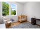 Bright Bedroom featuring wood floors, a crib, large windows, and a comfortable rocking chair, ideal for a modern Gathering at 53 Daniel Se St, Atlanta, GA 30312