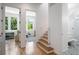 Hallway with hardwood floors leads to rooms with natural light, showcasing a clean, modern design and access to a bathroom at 53 Daniel Se St, Atlanta, GA 30312