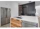 Close up of kitchen featuring stainless steel refrigerator and modern wood grain cabinets at 53 Daniel Se St, Atlanta, GA 30312