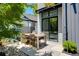 Outdoor patio with wooden dining table and chairs, lush landscaping, and modern home exterior at 53 Daniel Se St, Atlanta, GA 30312