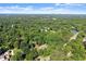 An aerial view of the home in its wooded setting at 5816 Chamblee Dunwoody Rd, Atlanta, GA 30338