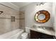 Bathroom with tub and shower combination, mosaic tile accents, granite countertops at 5816 Chamblee Dunwoody Rd, Atlanta, GA 30338