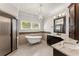 Elegant bathroom with clawfoot tub, granite counters, and a glass-enclosed shower at 5816 Chamblee Dunwoody Rd, Atlanta, GA 30338