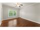Bedroom with hardwood floors, neutral paint, and natural light coming through window at 5816 Chamblee Dunwoody Rd, Atlanta, GA 30338
