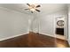 Comfortable bedroom with ceiling fan, access to an ensuite bathroom and hardwood floors at 5816 Chamblee Dunwoody Rd, Atlanta, GA 30338