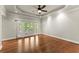 Large bedroom featuring hardwood floors, tray ceilings, recessed lighting, and access to a private balcony at 5816 Chamblee Dunwoody Rd, Atlanta, GA 30338