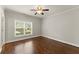 This bedroom is bright with natural light and features hardwood floors and a ceiling fan at 5816 Chamblee Dunwoody Rd, Atlanta, GA 30338