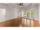 Spacious bedroom with hardwood floors, tray ceilings, recessed lighting, and access to a private balcony at 5816 Chamblee Dunwoody Rd, Atlanta, GA 30338