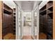 Walk-in closet with custom shelving and storage and doors leading to bathroom at 5816 Chamblee Dunwoody Rd, Atlanta, GA 30338