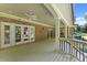 Covered porch features brickwork, recessed lighting and a ceiling fan at 5816 Chamblee Dunwoody Rd, Atlanta, GA 30338