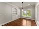 Charming dining area with hardwood floors, modern lighting, and built-in shelving for elegant storage at 5816 Chamblee Dunwoody Rd, Atlanta, GA 30338