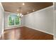 Dining room featuring hardwood floors, chandelier, and natural light at 5816 Chamblee Dunwoody Rd, Atlanta, GA 30338