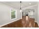 Open dining area with hardwood floors and modern lighting, seamlessly flowing into adjoining rooms at 5816 Chamblee Dunwoody Rd, Atlanta, GA 30338