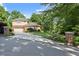 Charming home with long driveway, lush lawn and mature landscaping at 5816 Chamblee Dunwoody Rd, Atlanta, GA 30338