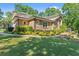 Brick home featuring a lush green lawn and mature trees at 5816 Chamblee Dunwoody Rd, Atlanta, GA 30338