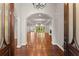 Grand entrance with hardwood floors, arched doorways, and elegant chandelier at 5816 Chamblee Dunwoody Rd, Atlanta, GA 30338