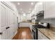 Well-lit kitchen with granite countertops, stainless steel appliances, and ample cabinet space at 5816 Chamblee Dunwoody Rd, Atlanta, GA 30338