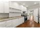 Bright kitchen featuring stainless steel appliances, granite countertops, and modern white cabinets at 5816 Chamblee Dunwoody Rd, Atlanta, GA 30338
