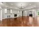 Bright living room with hardwood floors, fireplace, and built-in shelving at 5816 Chamblee Dunwoody Rd, Atlanta, GA 30338