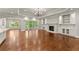 Open-concept living room with hardwood floors, fireplace, and built-in shelving at 5816 Chamblee Dunwoody Rd, Atlanta, GA 30338