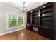 Elegant office space with dark wood built-in shelving and a large window offering natural light at 5816 Chamblee Dunwoody Rd, Atlanta, GA 30338