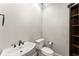 Bright half-bathroom featuring a modern sink, toilet, dark wood shelving at 5816 Chamblee Dunwoody Rd, Atlanta, GA 30338