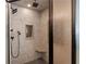 Modern walk-in shower featuring gray stone tile, a bench, and black shower fixtures at 5816 Chamblee Dunwoody Rd, Atlanta, GA 30338