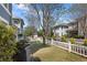 Well-maintained backyard featuring a white picket fence, green grass, and beautiful landscaping at 1338 Dupont Nw Park, Atlanta, GA 30318