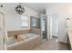 Relaxing bathroom with a soaking tub, glass-enclosed shower, and neutral tile at 1338 Dupont Nw Park, Atlanta, GA 30318