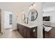 Bright bathroom features a double vanity with round mirrors and modern lighting at 1338 Dupont Nw Park, Atlanta, GA 30318