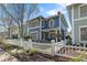 Beautifully landscaped home with a picket fence and a charming covered front porch at 1338 Dupont Nw Park, Atlanta, GA 30318