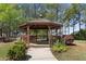 Charming gazebo with wood detailing, set amidst landscaped gardens and a sidewalk, perfect for gatherings at 1338 Dupont Nw Park, Atlanta, GA 30318