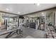 Full gym with weight machines, dumbbells, mirrored walls, and television at 1338 Dupont Nw Park, Atlanta, GA 30318