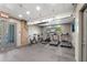 Bright workout area with treadmills, elliptical, stationary bikes, and stone wall at 1338 Dupont Nw Park, Atlanta, GA 30318