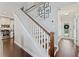 Staircase with hardwood steps, white risers, and hallway leading to the front door at 1338 Dupont Nw Park, Atlanta, GA 30318