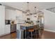 A kitchen boasts granite counters, stainless appliances, a dark island, and hardwood floors at 1338 Dupont Nw Park, Atlanta, GA 30318