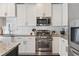 Gourmet kitchen with stainless steel appliances and granite counters and tiled backsplash at 1338 Dupont Nw Park, Atlanta, GA 30318