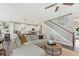 Open-concept living area flowing into the kitchen, featuring a staircase and stylish decor at 1338 Dupont Nw Park, Atlanta, GA 30318