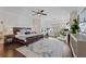 Spacious main bedroom with hardwood floors, ceiling fan, large rug, and ensuite bathroom at 1338 Dupont Nw Park, Atlanta, GA 30318