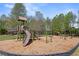 Community playground with slides and monkey bars, surrounded by a soft wood chip surface and green trees at 1338 Dupont Nw Park, Atlanta, GA 30318