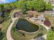 Scenic aerial view of a community pond with a stone fireplace and lush landscaping at 1338 Dupont Nw Park, Atlanta, GA 30318